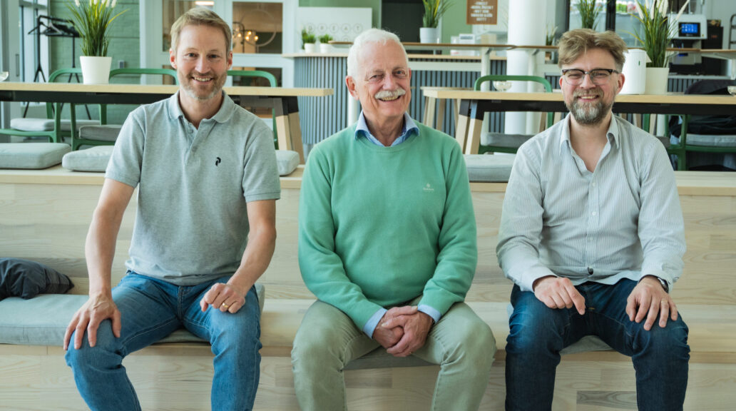 The three co-founders sitting together in a sofa inside.