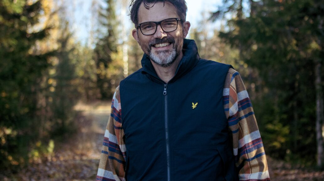 Jonas standing in the forest.