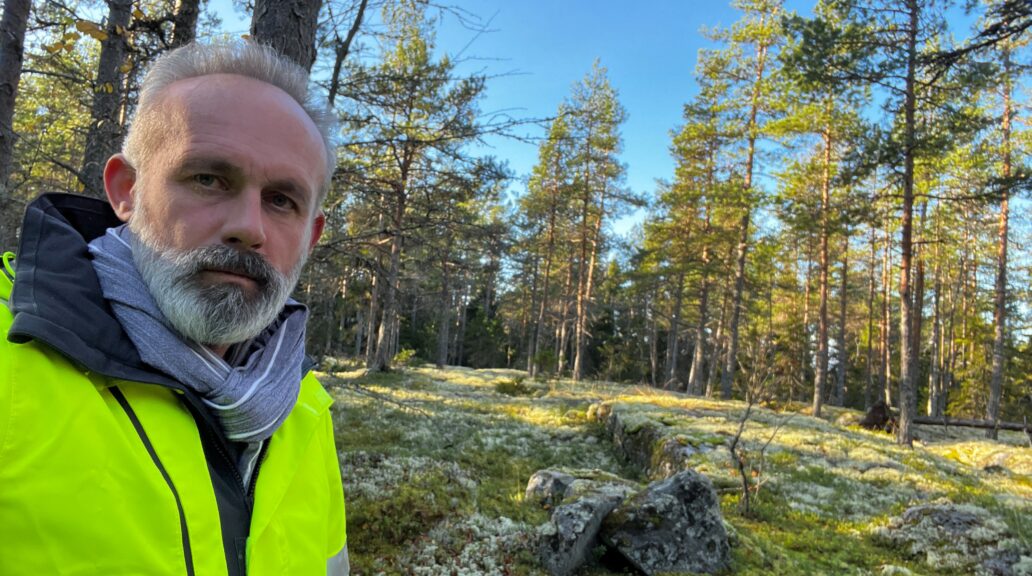 Daniel Pacurar in the forest, wearing a neon yellow jacket.