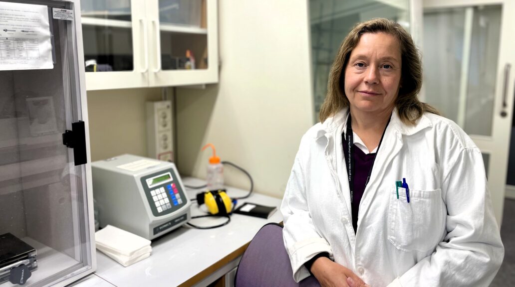 Ingela in a laboratory wearing a white lab coat.